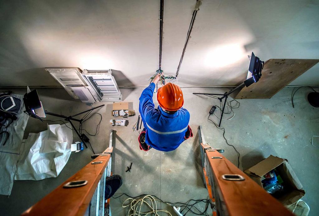 Electrician running wires through conduit